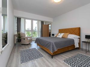 a bedroom with a large bed and a large window at Villa Green Castle - Five bedroom villa with swimming pool in Zadvarje +37 photos