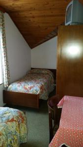 Cama o camas de una habitación en B&B Rosalpina