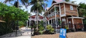 a house with a gate in front of it at Caye Caulker Boutique Guesthouse 5 in Caye Caulker