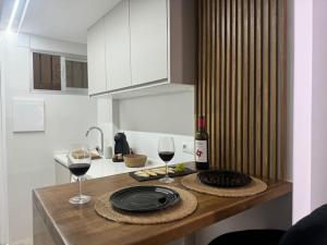a kitchen with a table with two glasses of wine at Benalmádena Costa! Nuevo estudio cerca del mar in Benalmádena