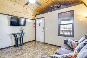 a living room with a couch and a window at Charming Cabin Near Great Smoky Mountains! in Newport