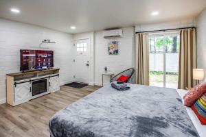 a bedroom with a large bed and a fireplace at Newly Renovated Bright Studio in Rochester