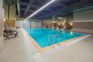 a large swimming pool in a hotel room at Best Western Plus Hotel & Residences Istanbul in Istanbul