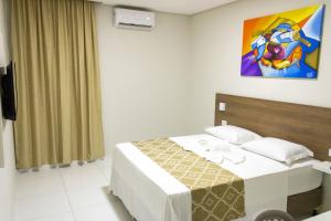 Ένα ή περισσότερα κρεβάτια σε δωμάτιο στο Paraiso Barra Hotel