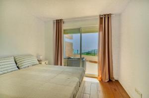 a bedroom with a bed and a window with a view at Isea & Sun Calaceite in Torrox Costa +33 photos