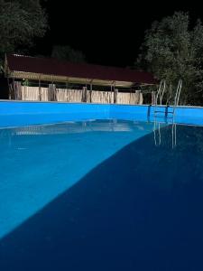 a blue swimming pool with two chairs in the water at Tiran in Getapʼ +25 photos