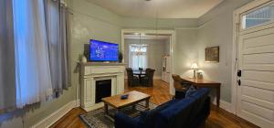 a living room with a blue couch and a fireplace at Dauphin District Darling #1-Downtown, Restaurants in Mobile
