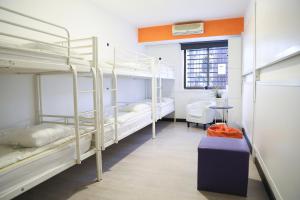 a room with three bunk beds and a table at Hostels Meetingpoint in Madrid