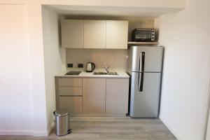 a kitchen with a refrigerator and a sink at Espacio nuevo, tranquilo y céntrico en Bariloche in San Carlos de Bariloche +19 photos