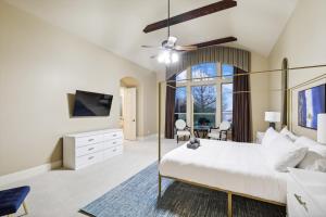 a bedroom with a large bed and a tv at Lakefront Mansion with Pool and Cinema in Rowlett +49 photos