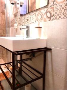 a bathroom with a white sink and a mirror at al VECCHIO ARCO Borgo Antico in Bari +24 photos