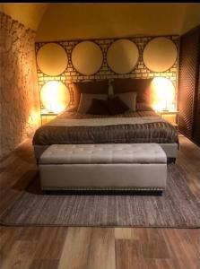 a bedroom with a bed with mirrors on the wall at al VECCHIO ARCO Borgo Antico in Bari