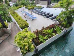 an aerial view of a pool with chairs and trees at Veloche Karon 12 in Karon Beach