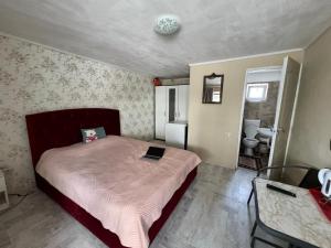 a bedroom with a bed with a laptop on it at Camere individuale cu baie proprie in Timisoara in Timişoara
