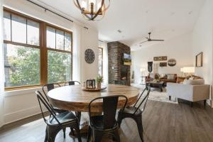 a dining room with a wooden table and chairs at Evergreen On Main in Blowing Rock