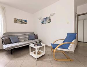 a living room with a couch and a chair at Apartment Sea Garden in Ičići