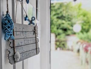 a sign that reads life is better at the beach at Apartment Sea Garden in Ičići