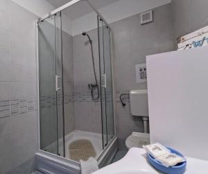 a bathroom with a shower and a toilet and a sink at Apartment Sea Garden in Ičići +37 photos