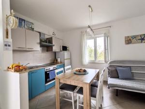 a kitchen and dining room with a table and a room at Apartment Sea Garden in Ičići