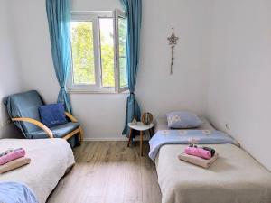 a room with two beds and a window at Apartment Sea Garden in Ičići