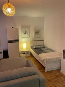 a living room with a bed and a couch at Appartement Kirschblüte in Seehof
