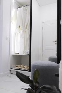 a mirror in a room with a chair and a robe at Бизнес-класса in Kostanay