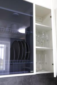 a cabinet filled with glasses and wine glasses at Бизнес-класса in Kostanay