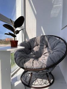 a circular chair sitting in front of a window at Бизнес-класса in Kostanay