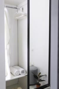 a mirror in a closet with towels and a plant at Бизнес-класса in Kostanay +16 photos