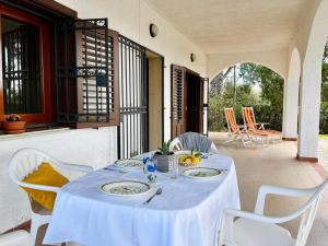 a table with a white table cloth on a patio at Villa la Pineta in Arenella