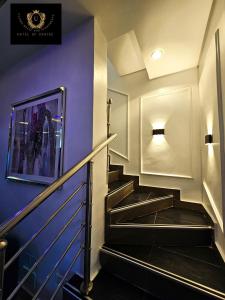 a staircase in a building with purple walls at 2 Bed Apartment 3 - Bright Benin City Stay in Benin City