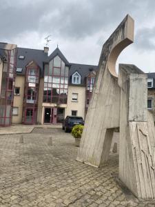 a sculpture in front of a building at Appartement cosy en duplex une chambre in Lamballe