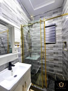 a bathroom with a sink and a shower at 2 Bed Apartment 7 - Tranquil Benin City Retreat in Benin City