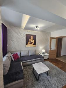 a living room with a couch and a table at AS Apartment in Podgorica