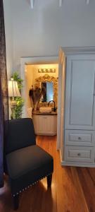 a living room with a chair and a mirror at Caye Caulker Boutique Guesthouse 6 in Caye Caulker