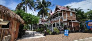 a house with a gate in front of it at Caye Caulker Boutique Guesthouse 6 in Caye Caulker
