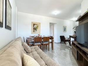 a living room with a couch and a dining room at Resid. Clube Mar Grosso - Laguna - LAG801 in Laguna