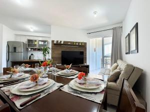 a living room with a table and a couch and a dining room at Resid. Clube Mar Grosso - Laguna - LAG801 in Laguna +49 photos
