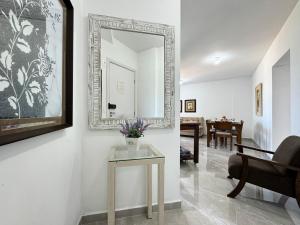 a living room with a mirror and a table at Resid. Clube Mar Grosso - Laguna - LAG801 in Laguna