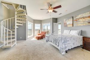 a bedroom with a bed and a spiral staircase at Oceanfront Galveston Beach House Steps to Sand! in Galveston