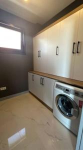 a kitchen with a washer and a washing machine at Villa RADA in Bogazici