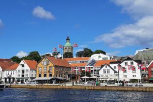 a town with a clock tower and a river at Harmony Home in Stavanger
