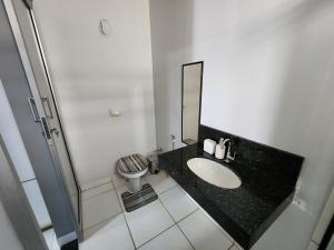 a bathroom with a sink and a toilet at Suíte3 Privativa Climatizada Mobiliada com Garagem e Wi-Fi in Goiânia
