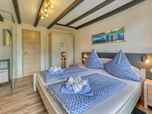 a bedroom with two beds with blue pillows at Holiday apartment Haus Leutner Bavarian Forest in Bodenmais