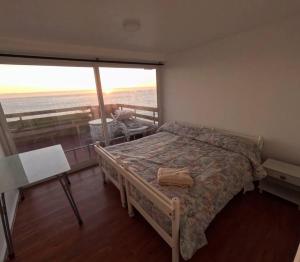 a bedroom with a bed and a view of the ocean at Reñaca Gran terraza con vista al mar in Viña del Mar