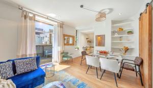 a living room with a blue couch and a table at DESIGNER Victorian Flat with HUGE Terrace in London