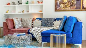 a living room with a blue couch and a table at DESIGNER Victorian Flat with HUGE Terrace in London +36 photos