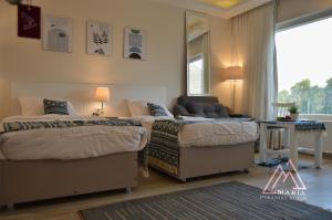 Letto o letti in una camera di Maria Pyramids House