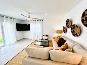 a living room with a couch and a flat screen tv at Villa Axarquia paraiso 88 Sinese Design Homes in Viñuela