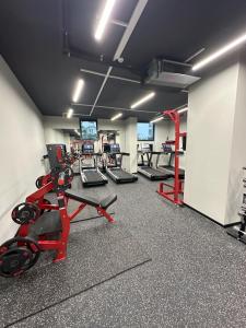 a gym with several treadmills and cardio machines at Bi Residence Sea View luxury Batumi in Batumi